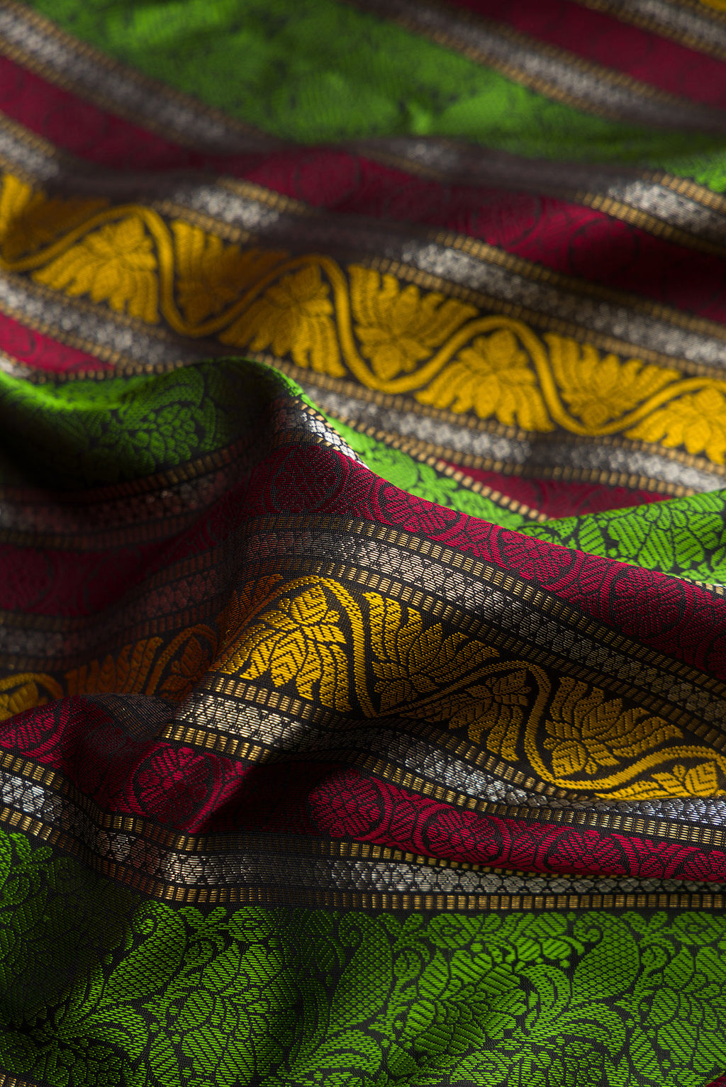 Close up of Pure Silk Multi Color Kanchipuram Saree with Jacquard design on the body and Zari And Thread Border.  displaying folds
