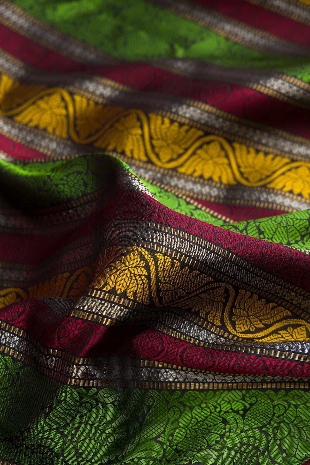 Close up of Pure Silk Multi Color Kanchipuram Saree with Jacquard design on the body and Zari And Thread Border.  displaying folds