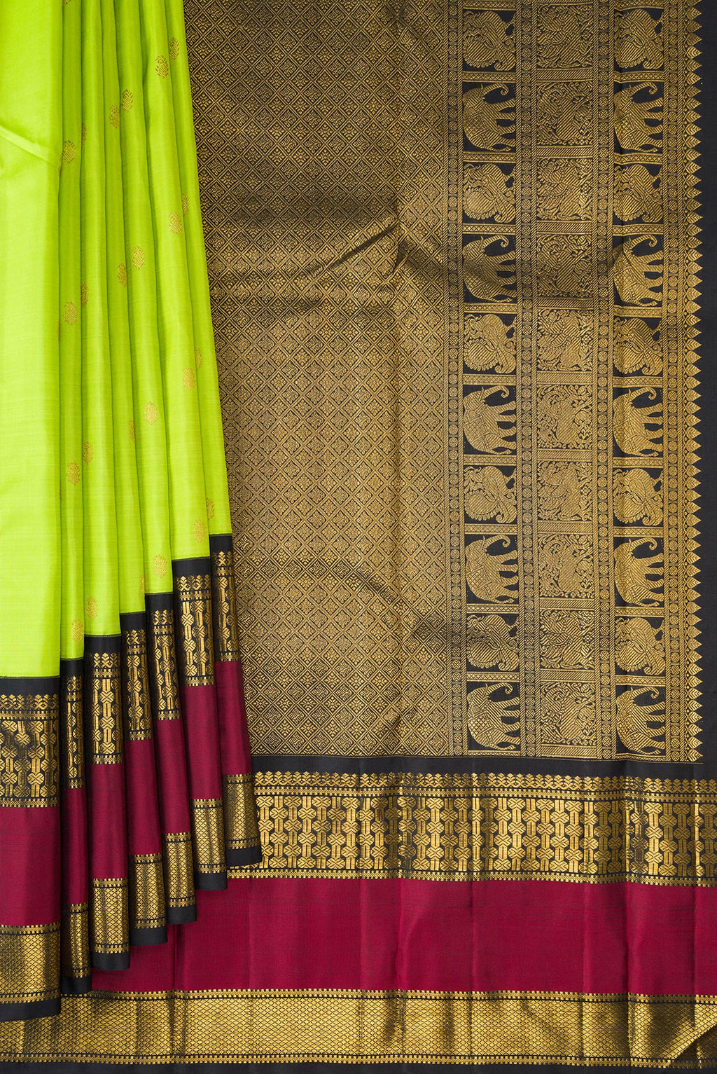 Pleats and pallu of Pure Silk Parrot Green Kanchipuram Saree with Zari Butta on the body and Zari Border. 