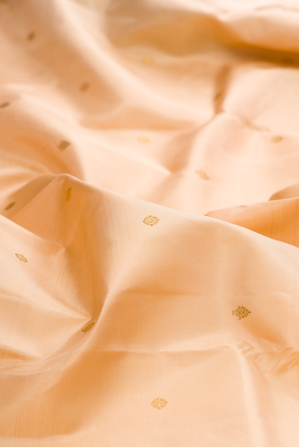 Close up of Pure Silk Sandal Kanchipuram Saree with Zari Butta on the body and Fancy Border.  displaying folds