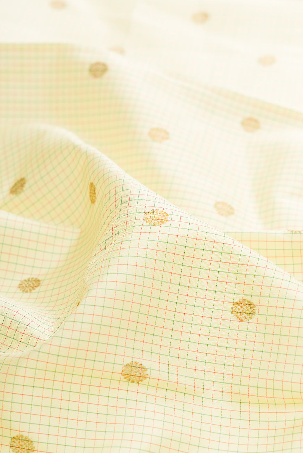 Close up of Pure Silk Cream Kanjivaram Saree with Checked design on the body and Zari Border.  displaying folds