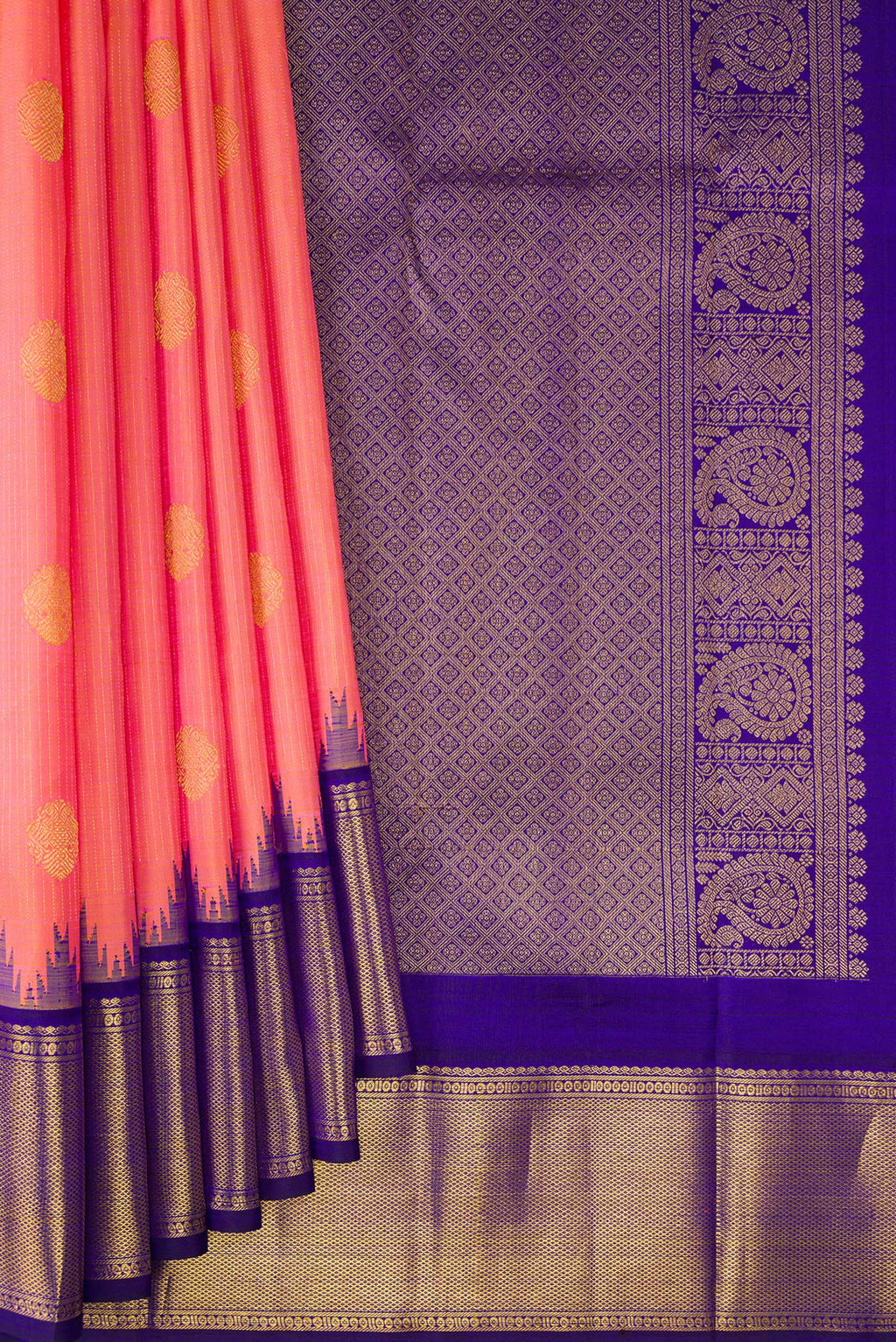 Pleats and pallu of Pure Silk Peach Kanchipuram Saree with Zari Butta on the body and Temple Border. 