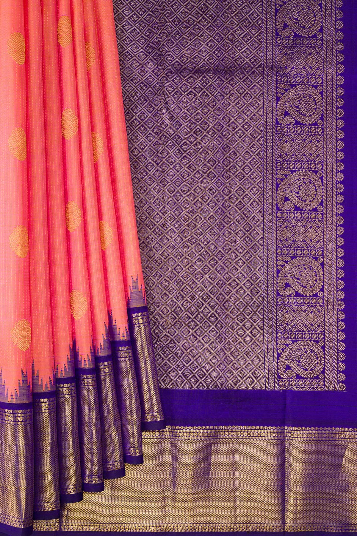 Pleats and pallu of Pure Silk Peach Kanchipuram Saree with Zari Butta on the body and Temple Border. 