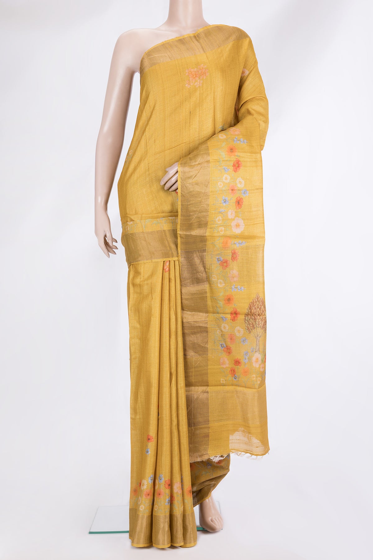 Mustard Tussar Saree with Printed design on the body and Zari Border.  displayed on a mannequin