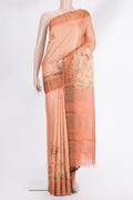 Peach Tussar Saree with Printed design on the body and Zari Border.  displayed on a mannequin