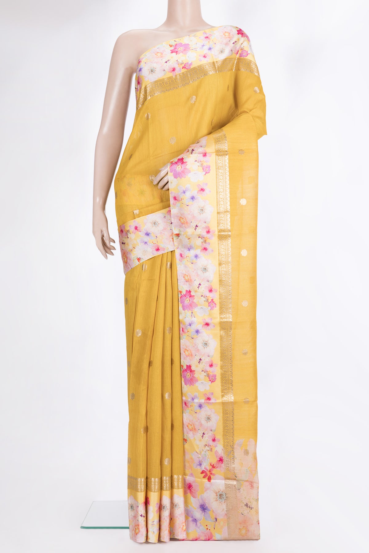 Yellow Tussar Saree with Zari Butta on the body and Fancy Border.  displayed on a mannequin