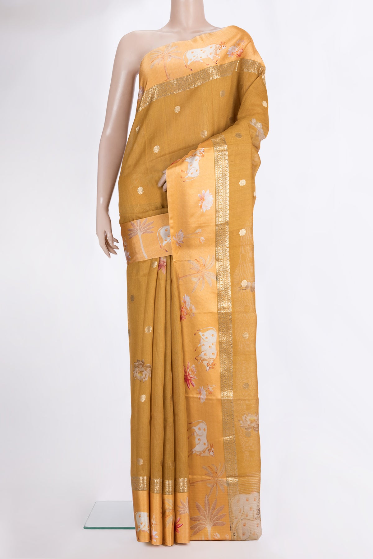 Mustard Tussar Saree with Zari Butta on the body and Fancy Border.  displayed on a mannequin