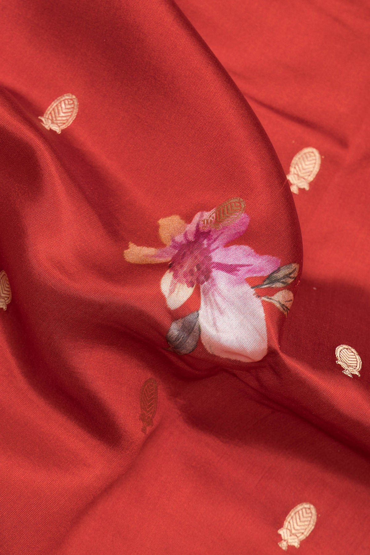 Close up of Maroon Tussar Saree with Zari Butta on the body and Fancy Border.  displaying folds