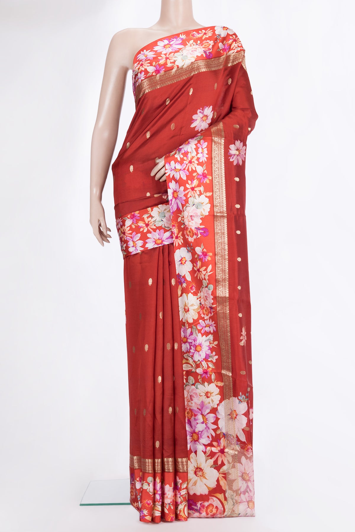 Maroon Tussar Saree with Zari Butta on the body and Fancy Border.  displayed on a mannequin