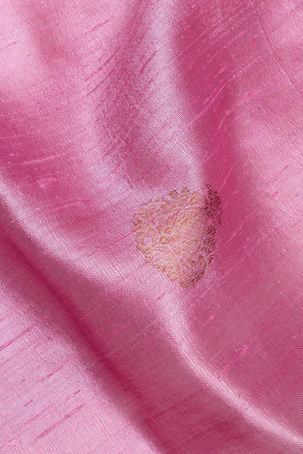 Close up of Pink Raw Saree with Zari Butta on the body and Zari Border.  displaying folds