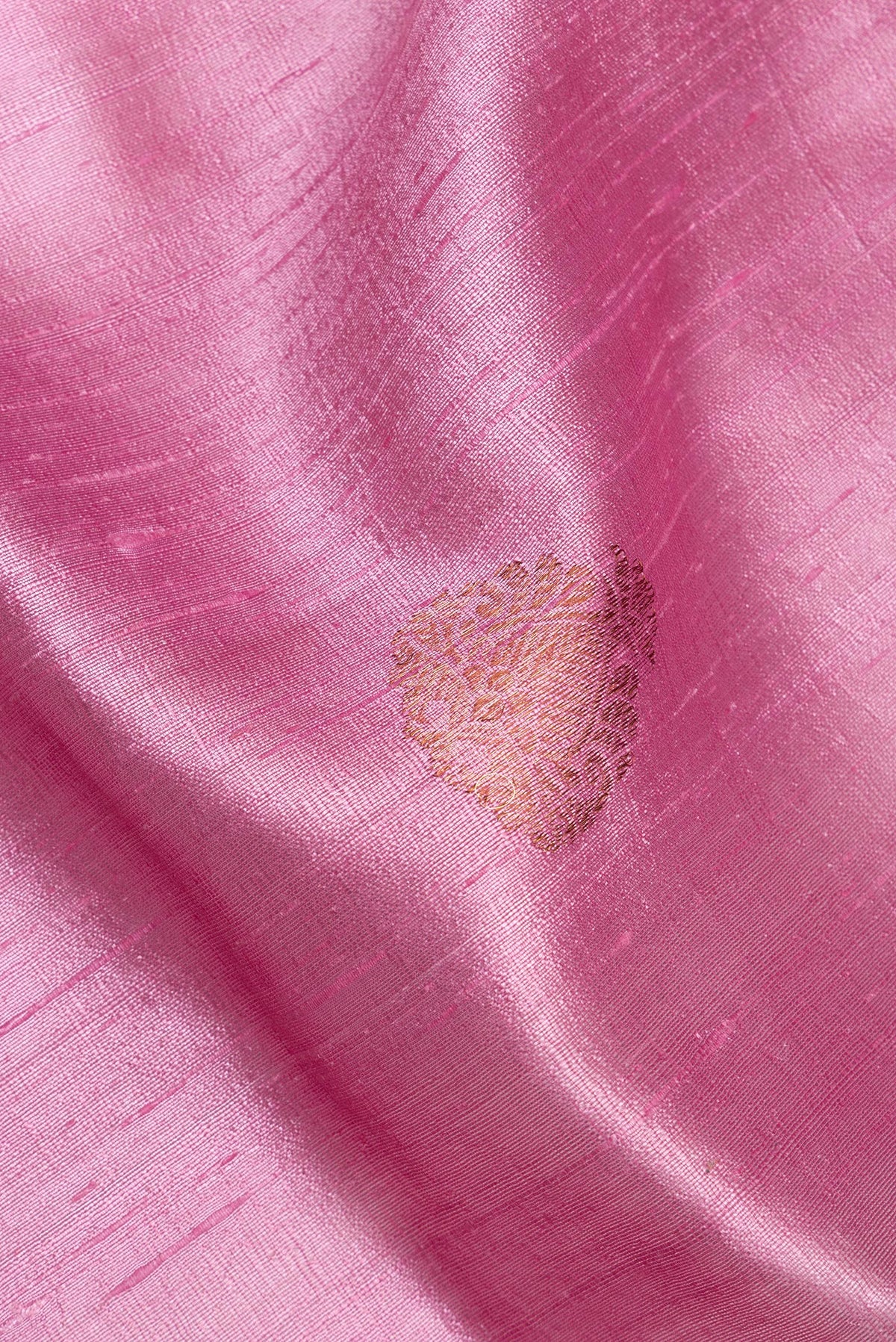 Close up of Pink Raw Saree with Zari Butta on the body and Zari Border.  displaying folds