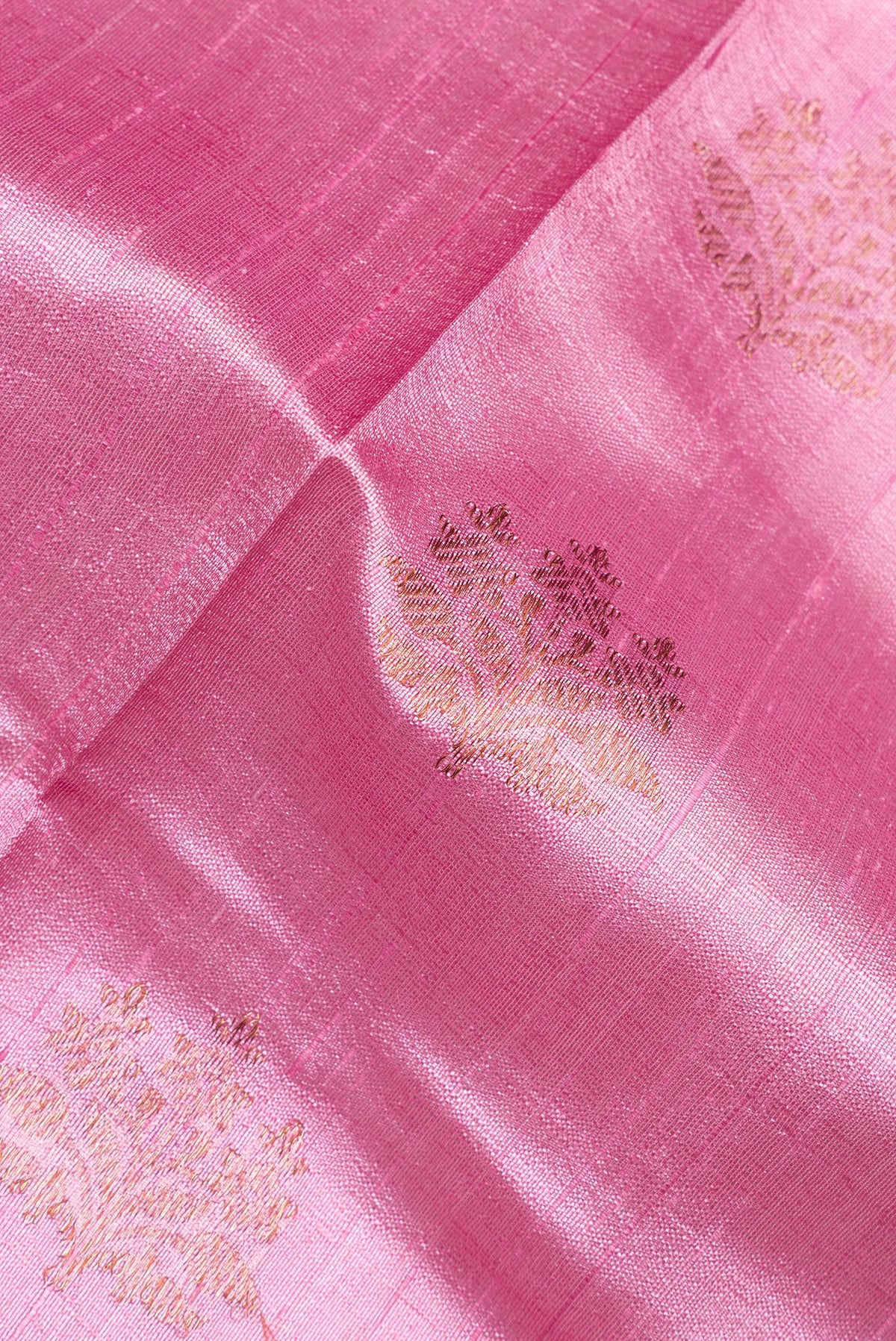 Close up of Rose pink Raw Saree with Zari Butta on the body and Zari Border.  displaying folds