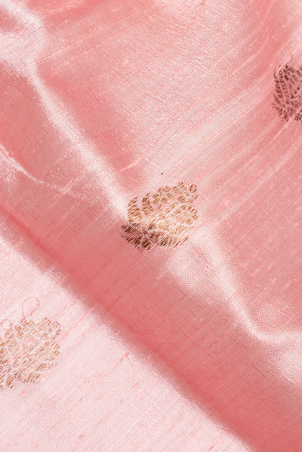 Close up of Rose pink Dual Tone Raw Saree with Zari Butta on the body and Zari Border.  displaying folds