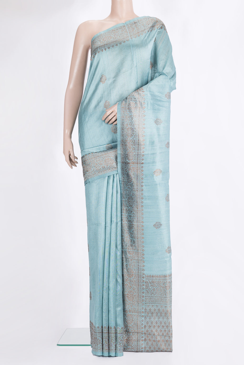 Light Blue Raw Saree with Zari Butta on the body and Zari Border.  displayed on a mannequin