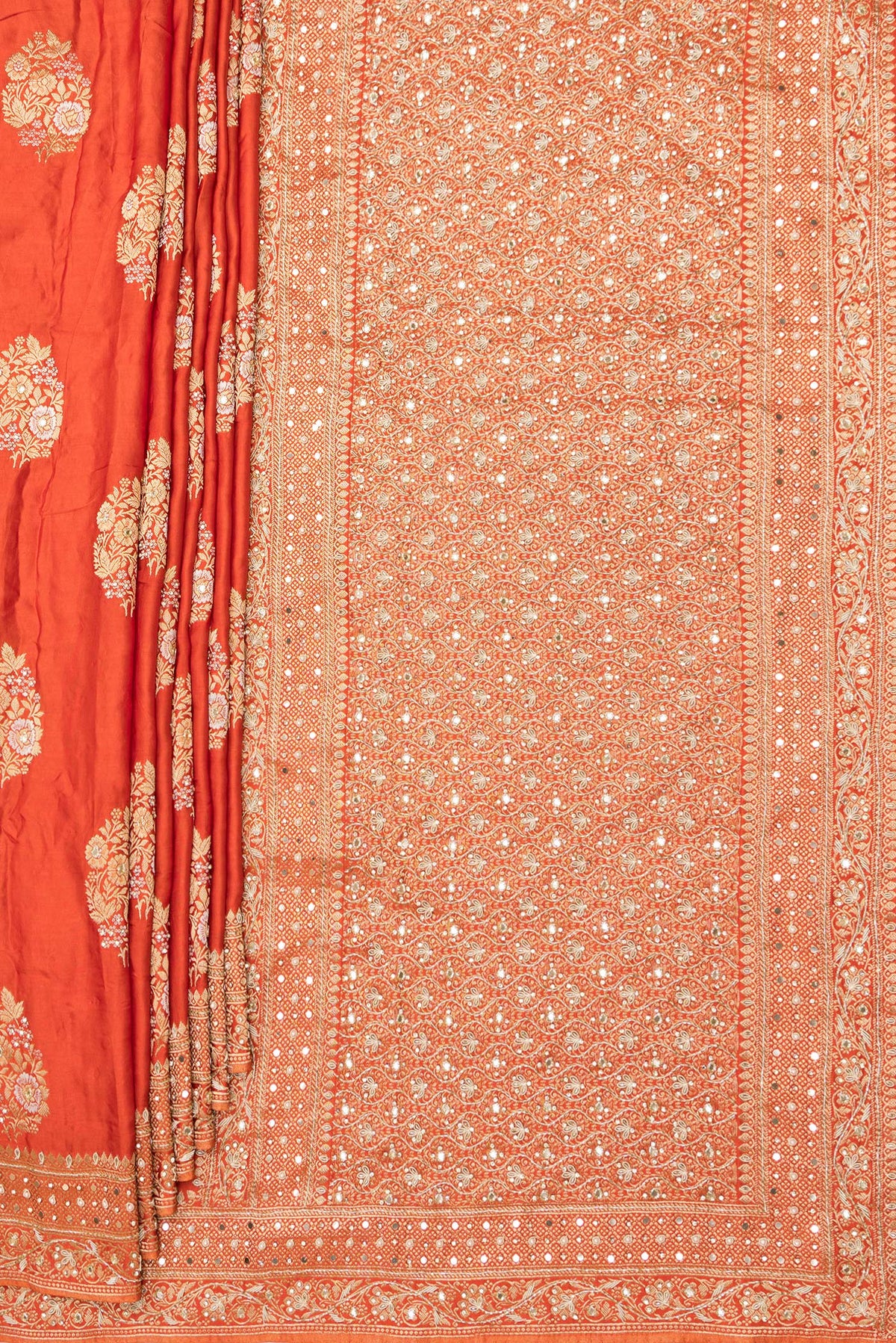Pleats and pallu of Orange Satin Saree with Embroidered on the body and Sequin Border. 