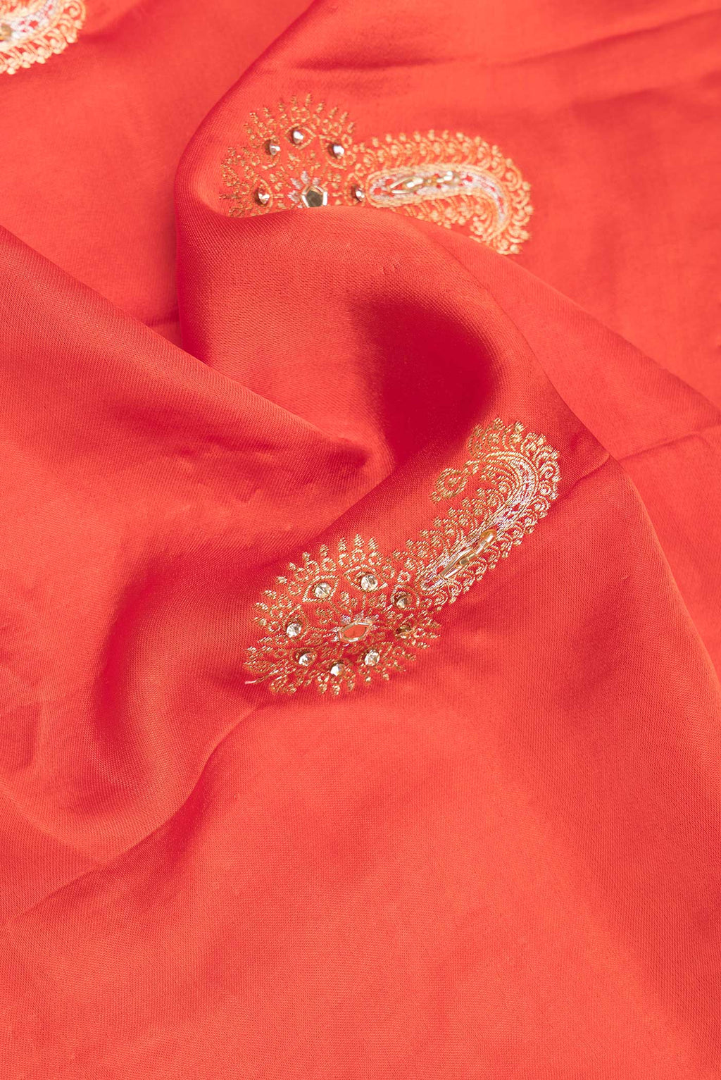 Close up of Brick Orange Satin Saree with Embroidered on the body and Sequin Border.  displaying folds
