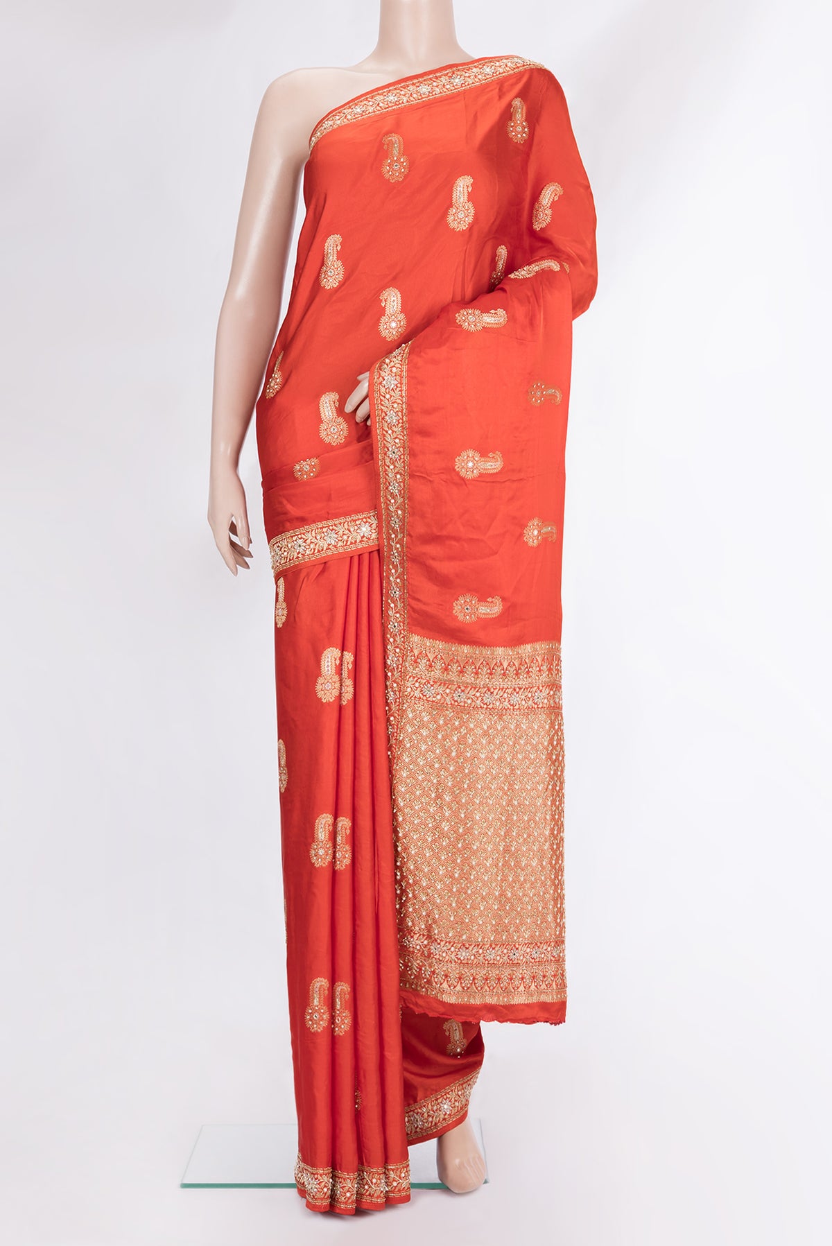 Brick Orange Satin Saree with Embroidered on the body and Sequin Border.  displayed on a mannequin