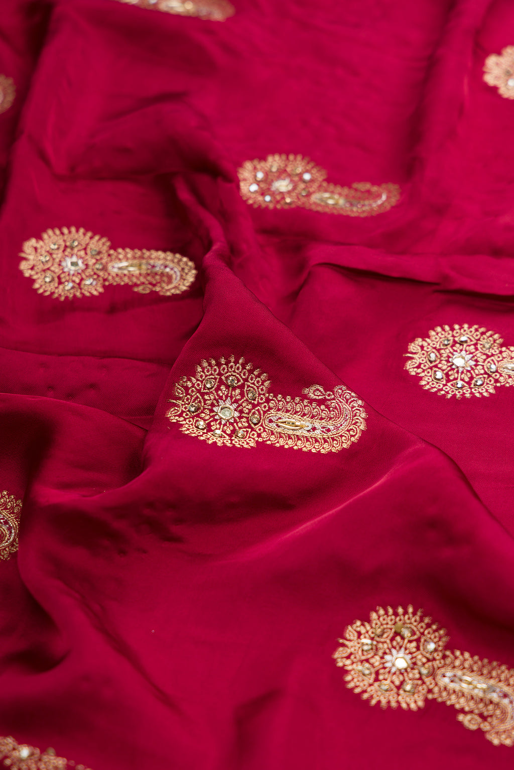Close up of Maroon Satin Crepe Saree with Embroidered on the body and Sequin Border.  displaying folds