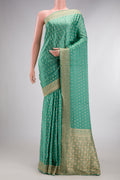 Sea Green Satin Crepe Saree with Embroidered on the body and Sequin Border.  displayed on a mannequin