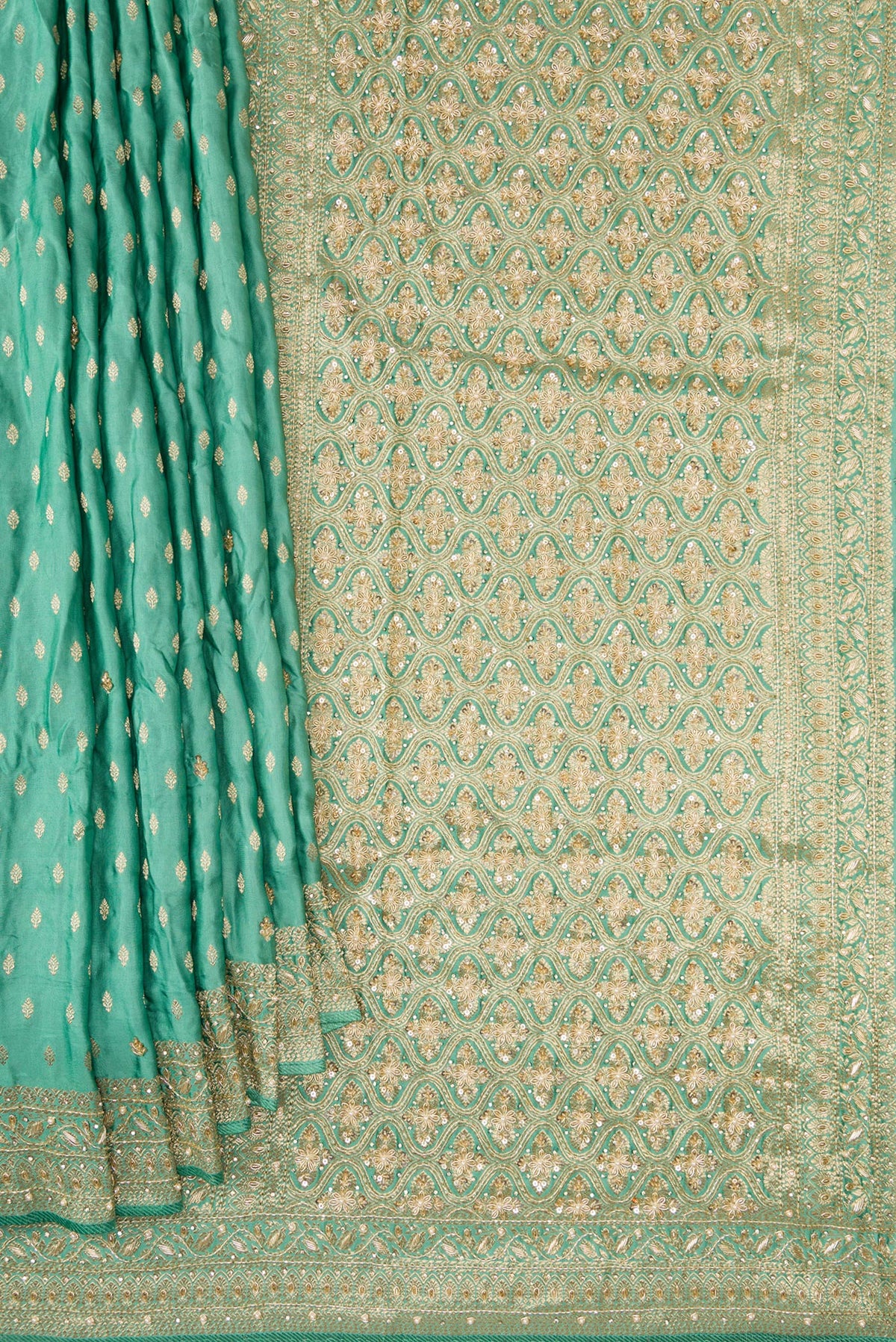 Pleats and pallu of Sea Green Satin Crepe Saree with Embroidered on the body and Sequin Border. 