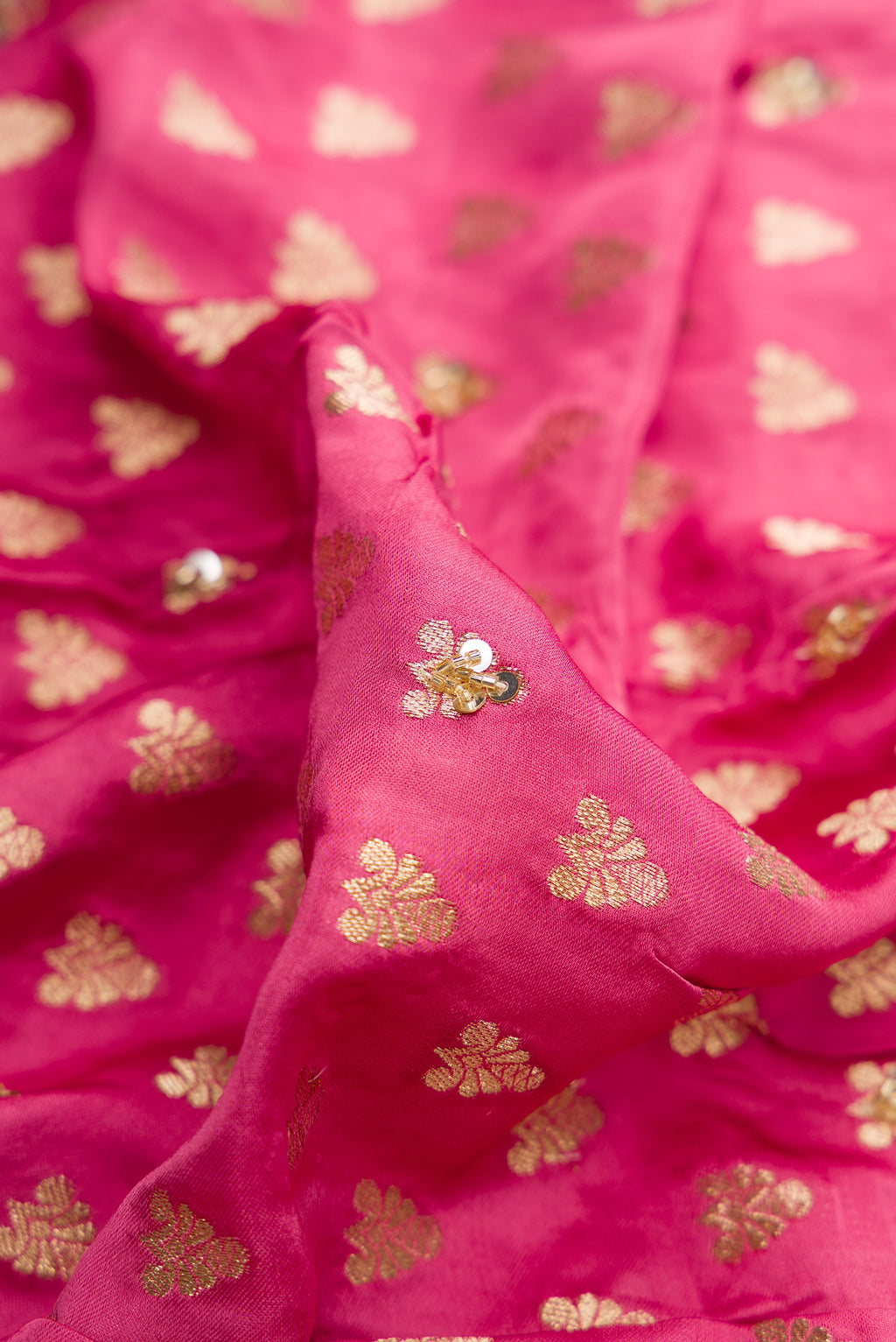 Close up of Pink Dual Tone Satin Crepe Saree with Embroidered on the body and Sequin Border.  displaying folds