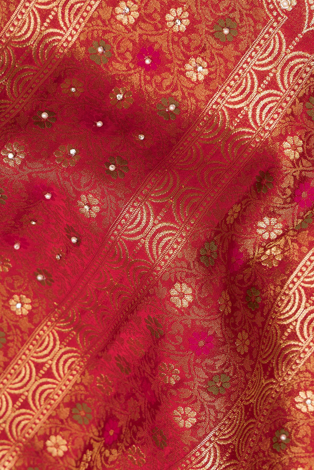 Close up of Red Crepe Saree with Embroidered on the body and Sequin Border.  displaying folds