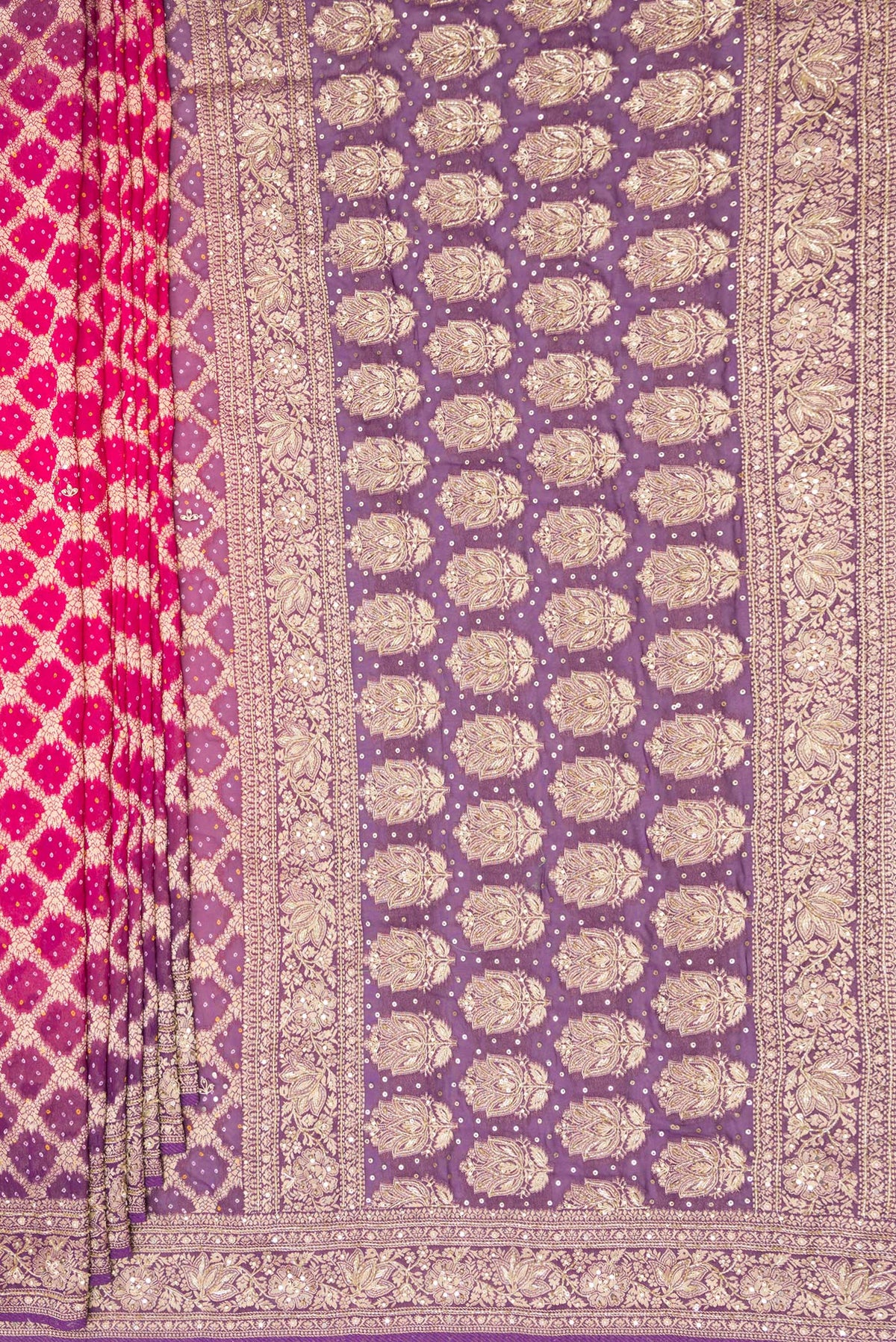 Pleats and pallu of Pink and Lavender Color Banarasi Georgette Saree with Bandhani Print on the body and Embroidered Border. 