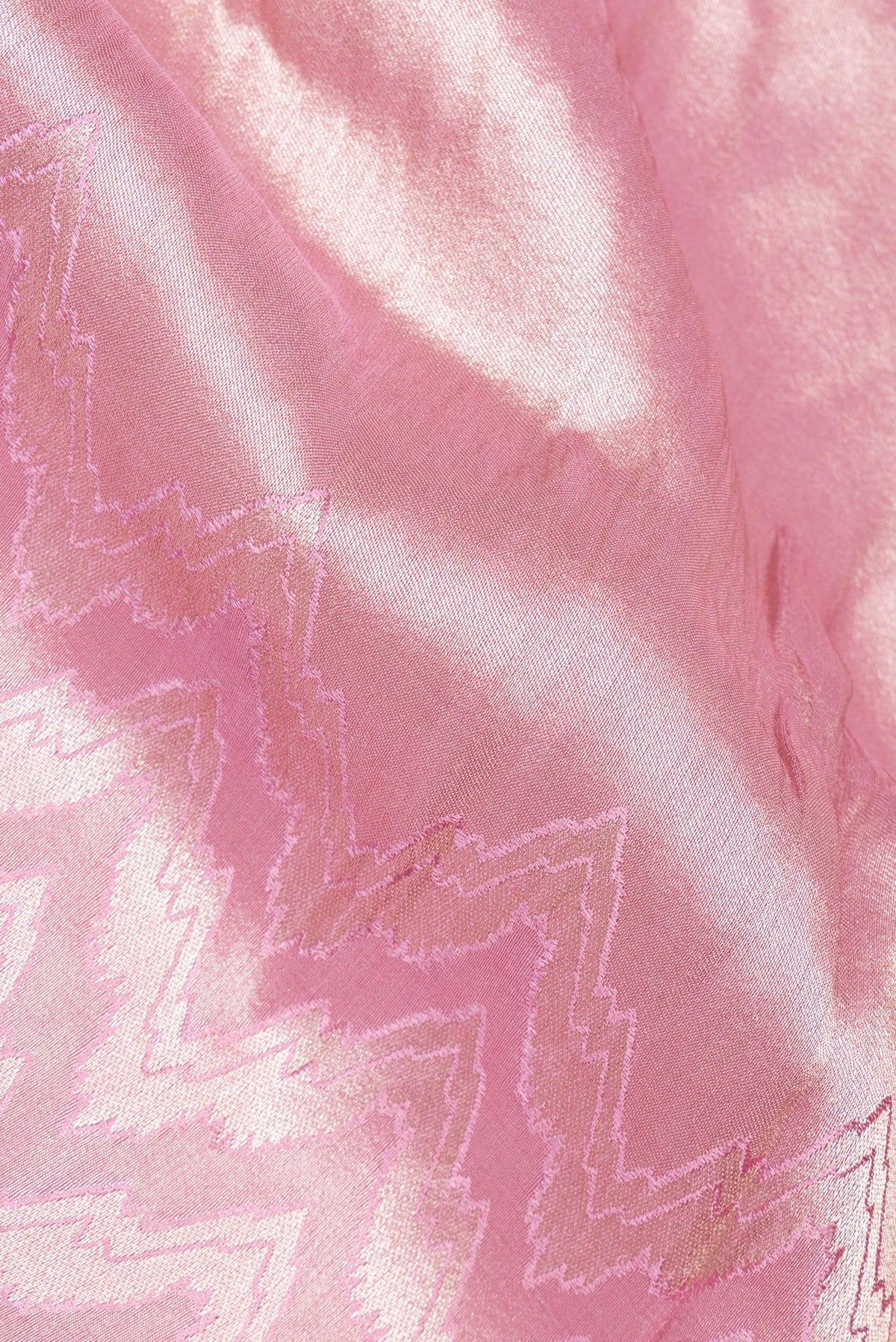 Close up of Rose pink Tissue Saree with Zari Brocade on the body and Sequin Border.  displaying folds