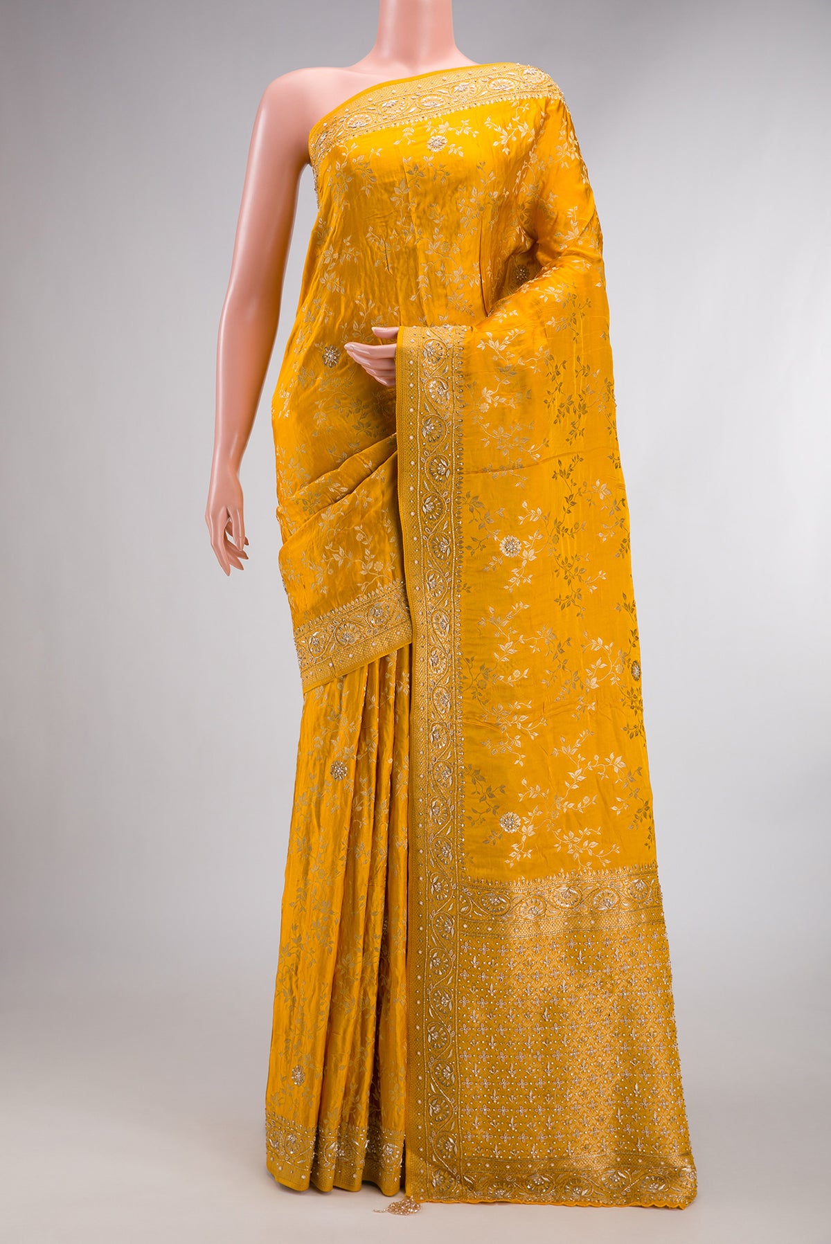 Yellow Satin Crepe Saree with Embroidered on the body and Sequin Border.  displayed on a mannequin