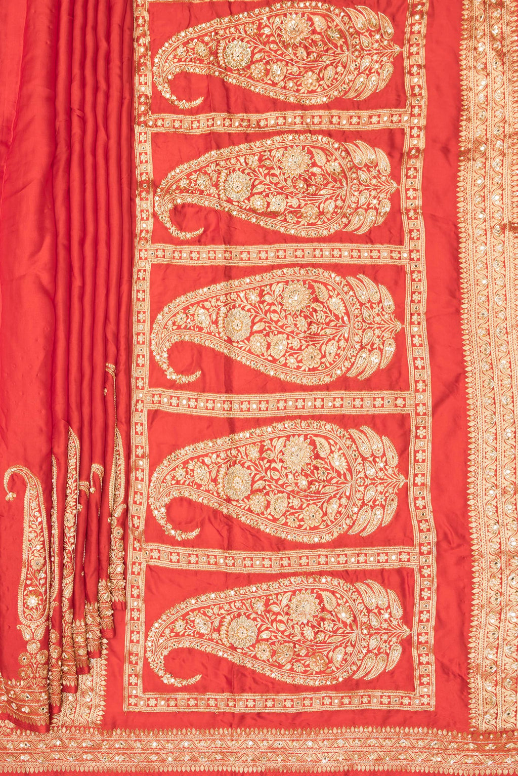 Pleats and pallu of Orange Satin Saree with Plain Body and Sequin Border. 