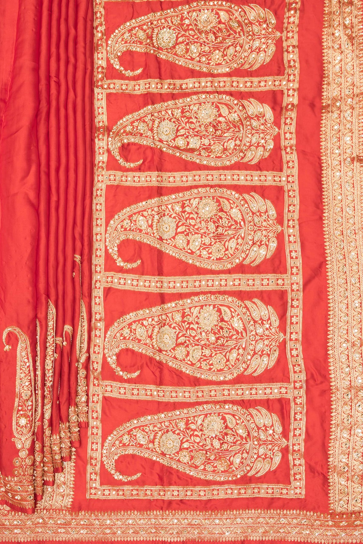 Pleats and pallu of Orange Satin Saree with Plain Body and Sequin Border. 
