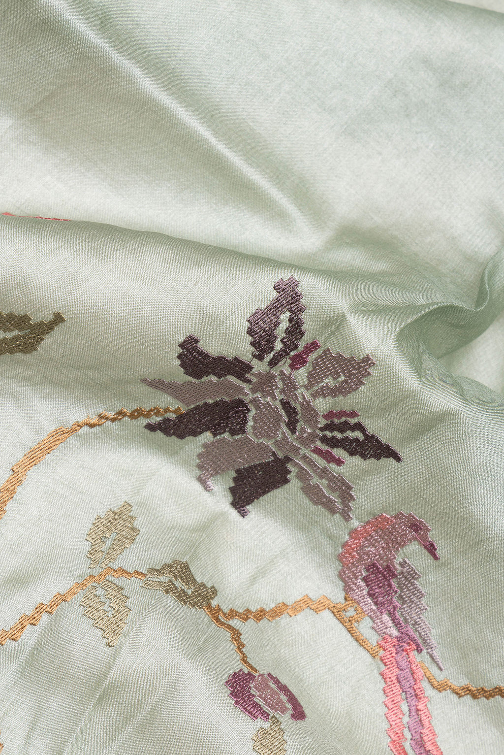 Close up of Light Green Tussar Saree with Embroidered on the body and Zari Border.  displaying folds