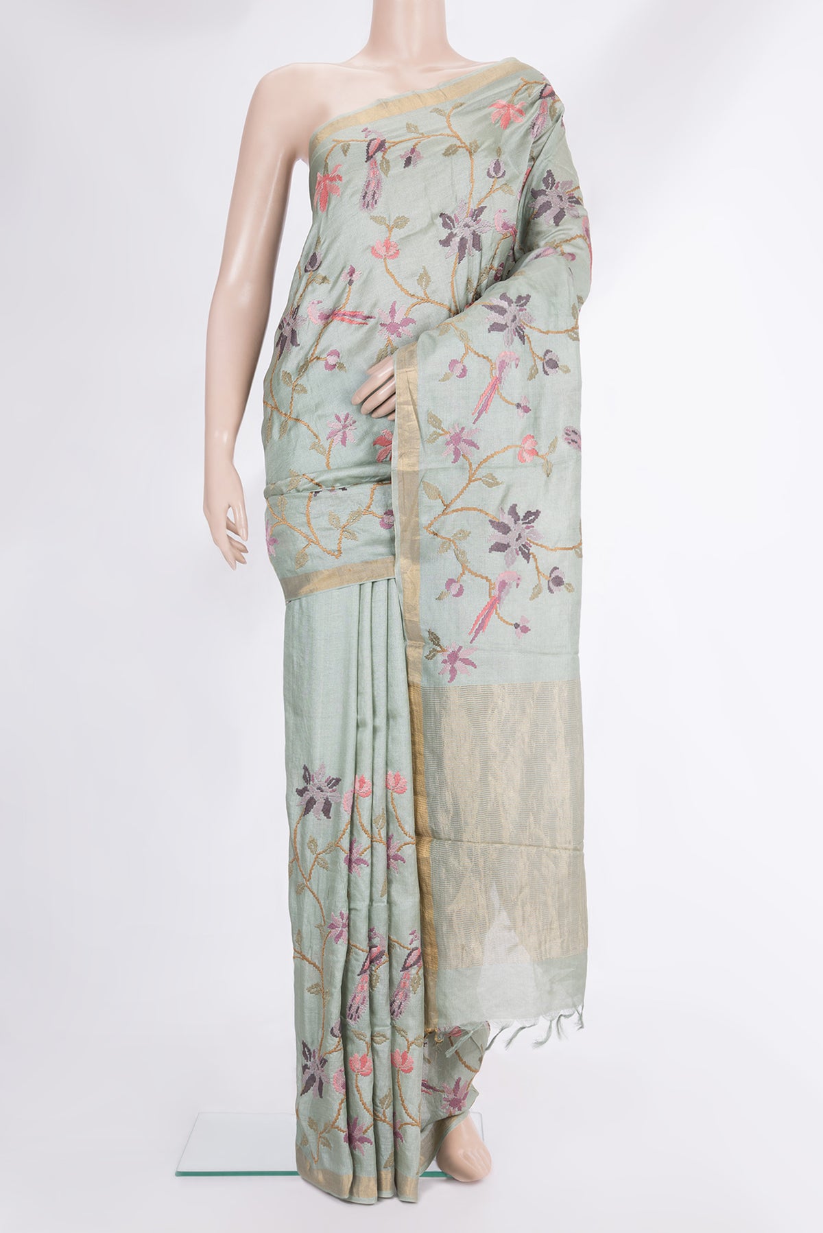 Light Green Tussar Saree with Embroidered on the body and Zari Border.  displayed on a mannequin