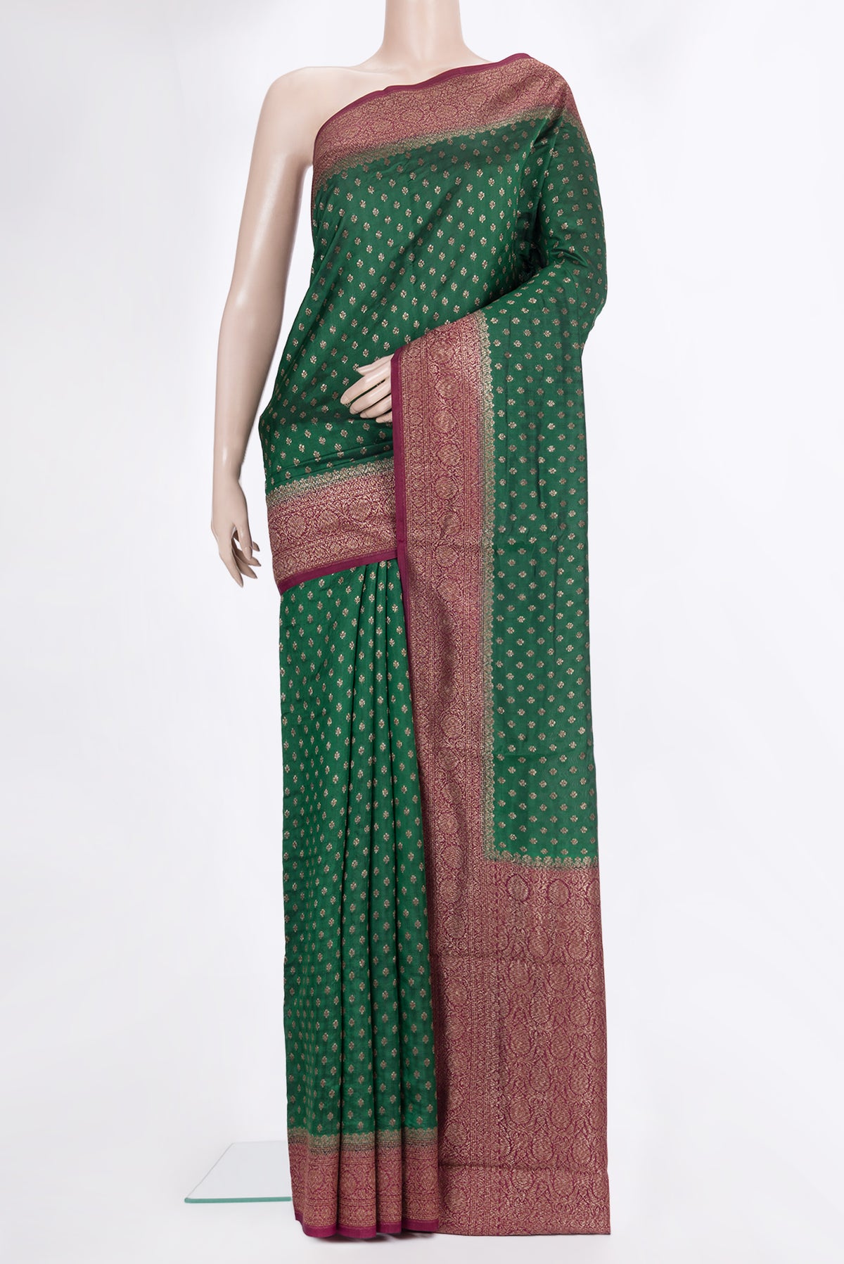 Pure Silk Bottle Green Tussar Saree with Zari Butta on the body and Zari Border.  displayed on a mannequin