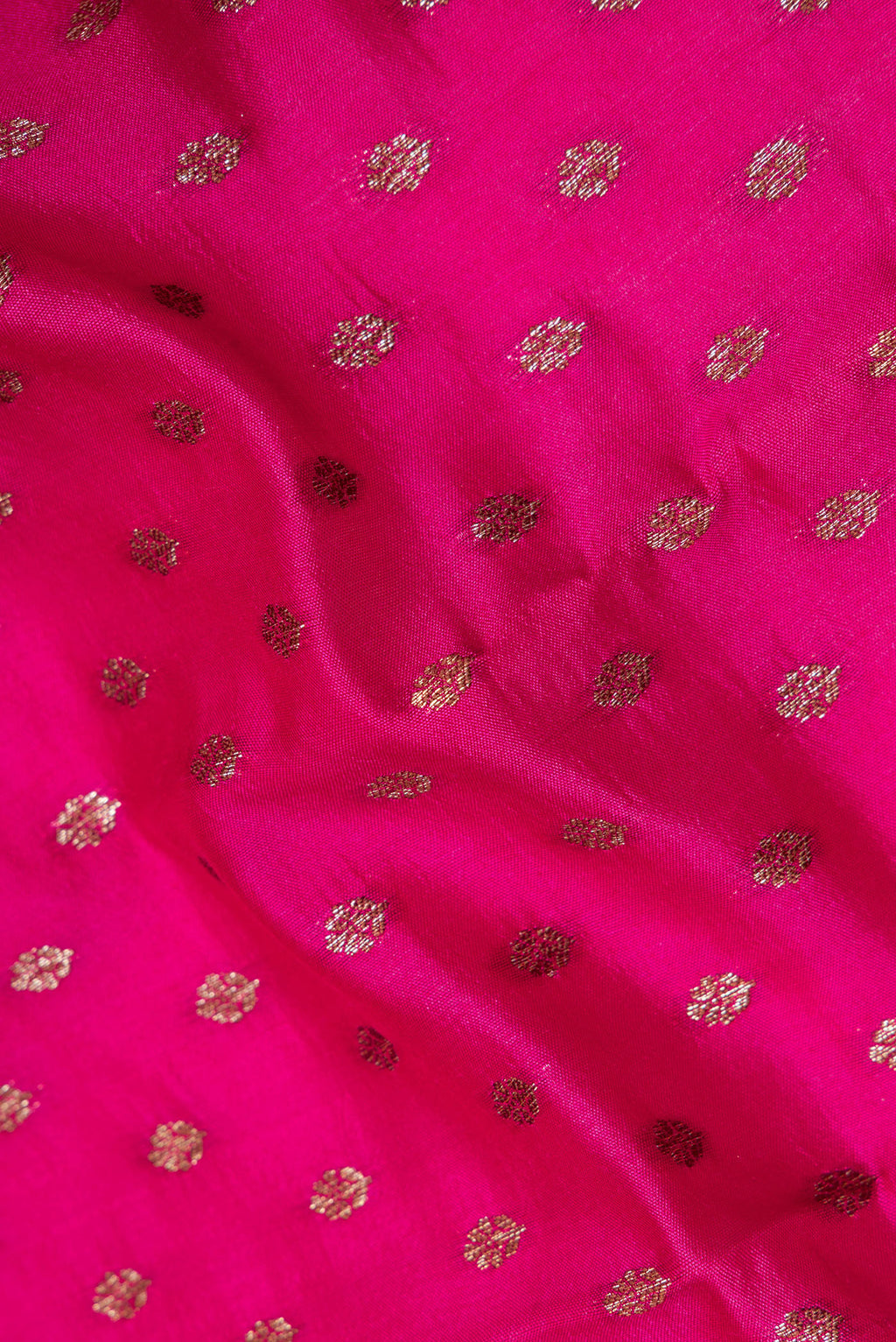 Close up of Pure Silk Dark Pink Tussar Saree with Zari Butta on the body and Zari Border.  displaying folds