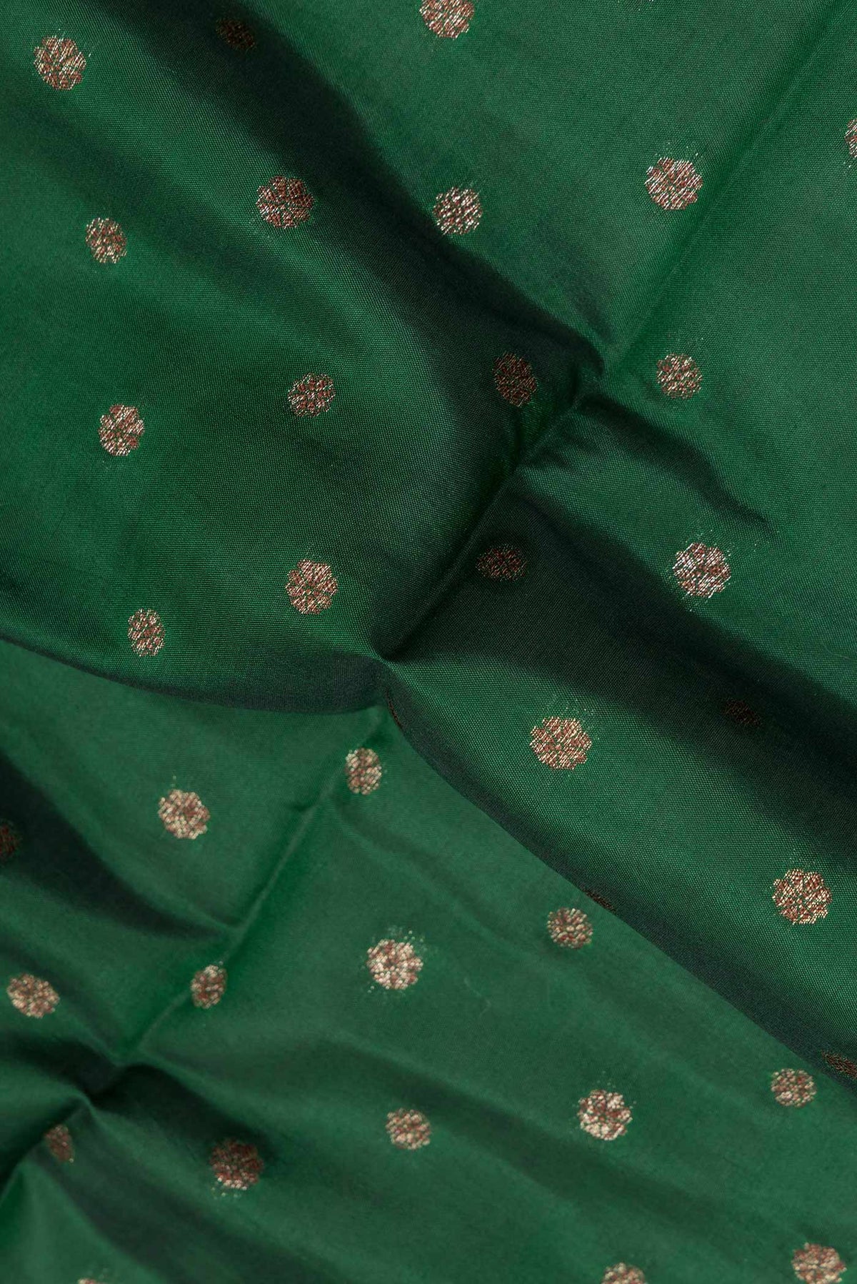 Close up of Pure Silk Bottle Green Tussar Saree with Zari Butta on the body and Zari Border.  displaying folds