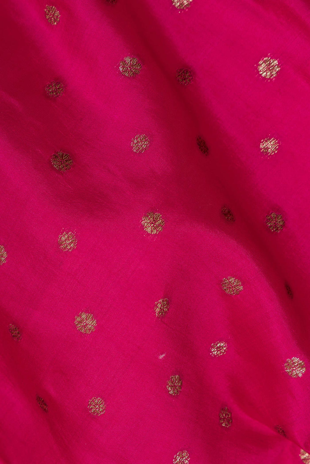 Close up of Pure Silk Dark Pink Tussar Saree with Zari Butta on the body and Zari Border.  displaying folds