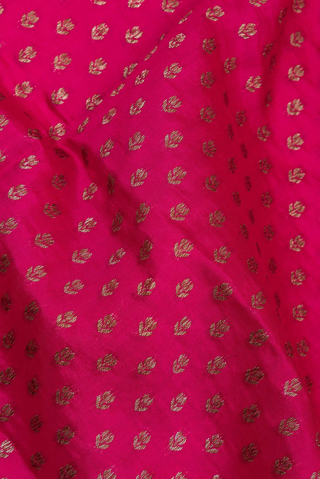 Close up of Pure Silk Dark Pink Tussar Saree with Zari Butta on the body and Zari Border.  displaying folds