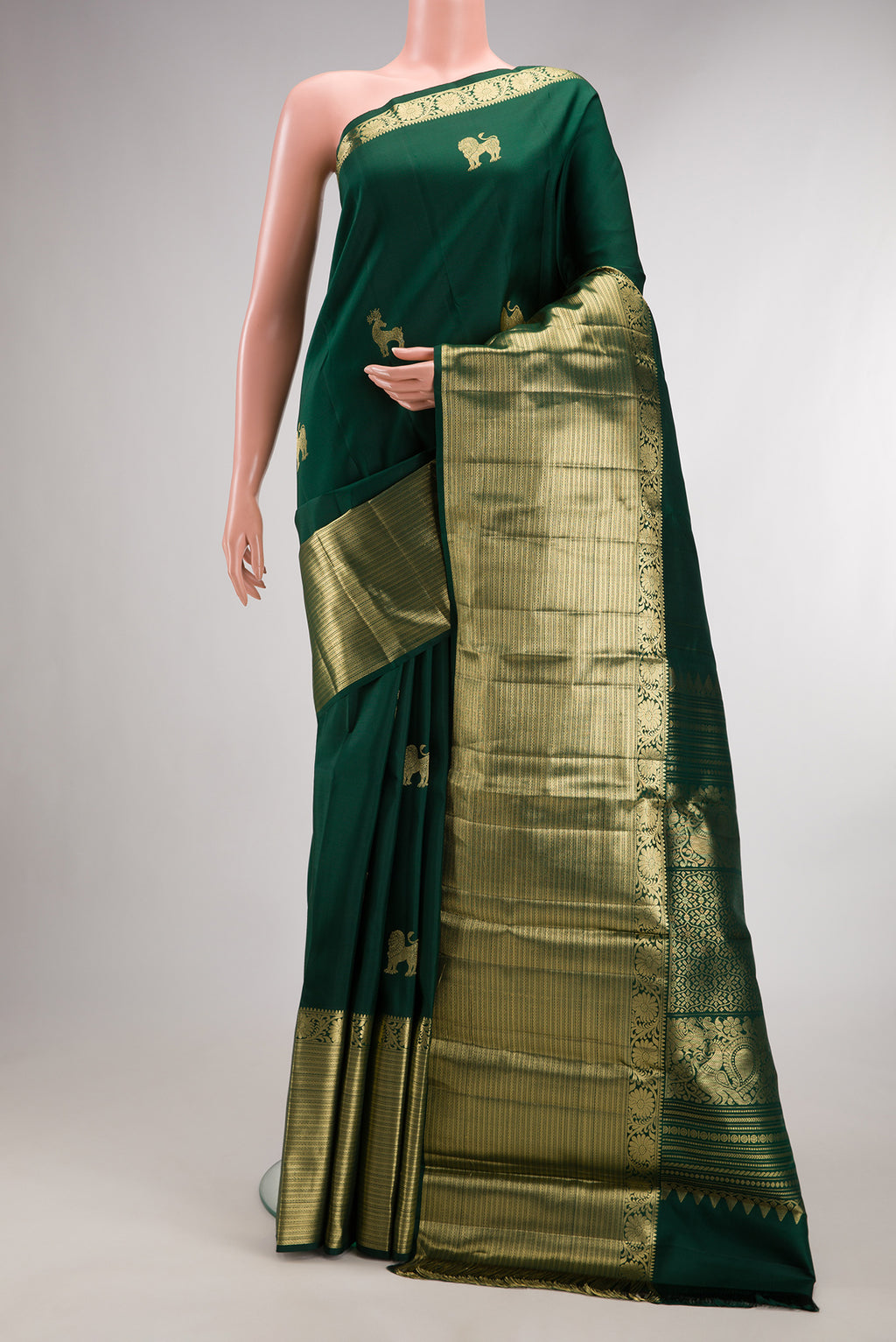 Pure Silk Bottle Green Kanjivaram Saree with Zari Butta on the body and Zari Border.  displayed on a mannequin