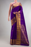 Pure Silk Violet Kanjivaram Saree with Zari Butta on the body and Zari Border.  displayed on a mannequin
