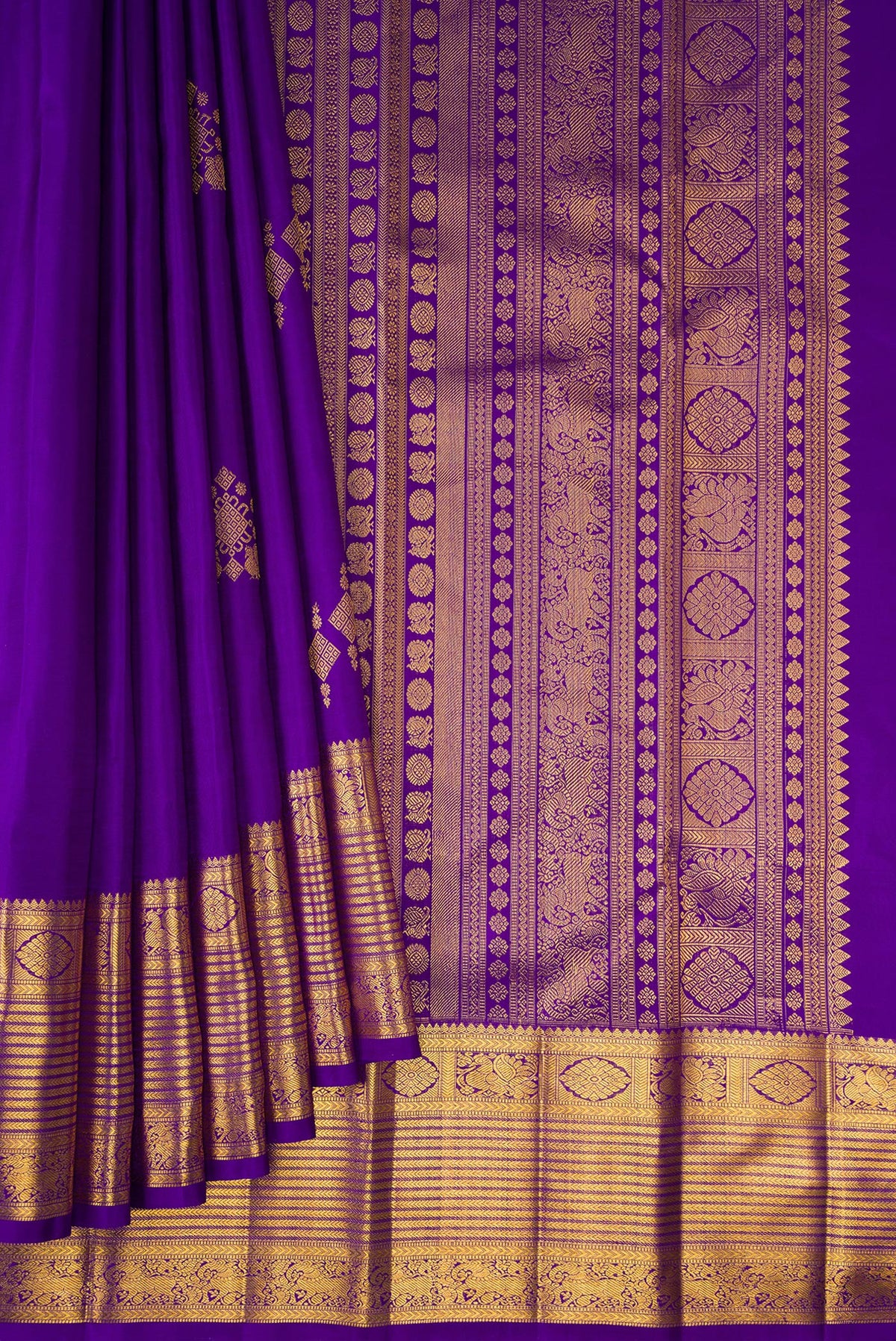 Pleats and pallu of Pure Silk Violet Kanjivaram Saree with Zari Butta on the body and Zari Border. 