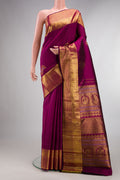 Pure Silk Magenta Kanjivaram Saree with Zari Butta on the body and Zari Border.  displayed on a mannequin