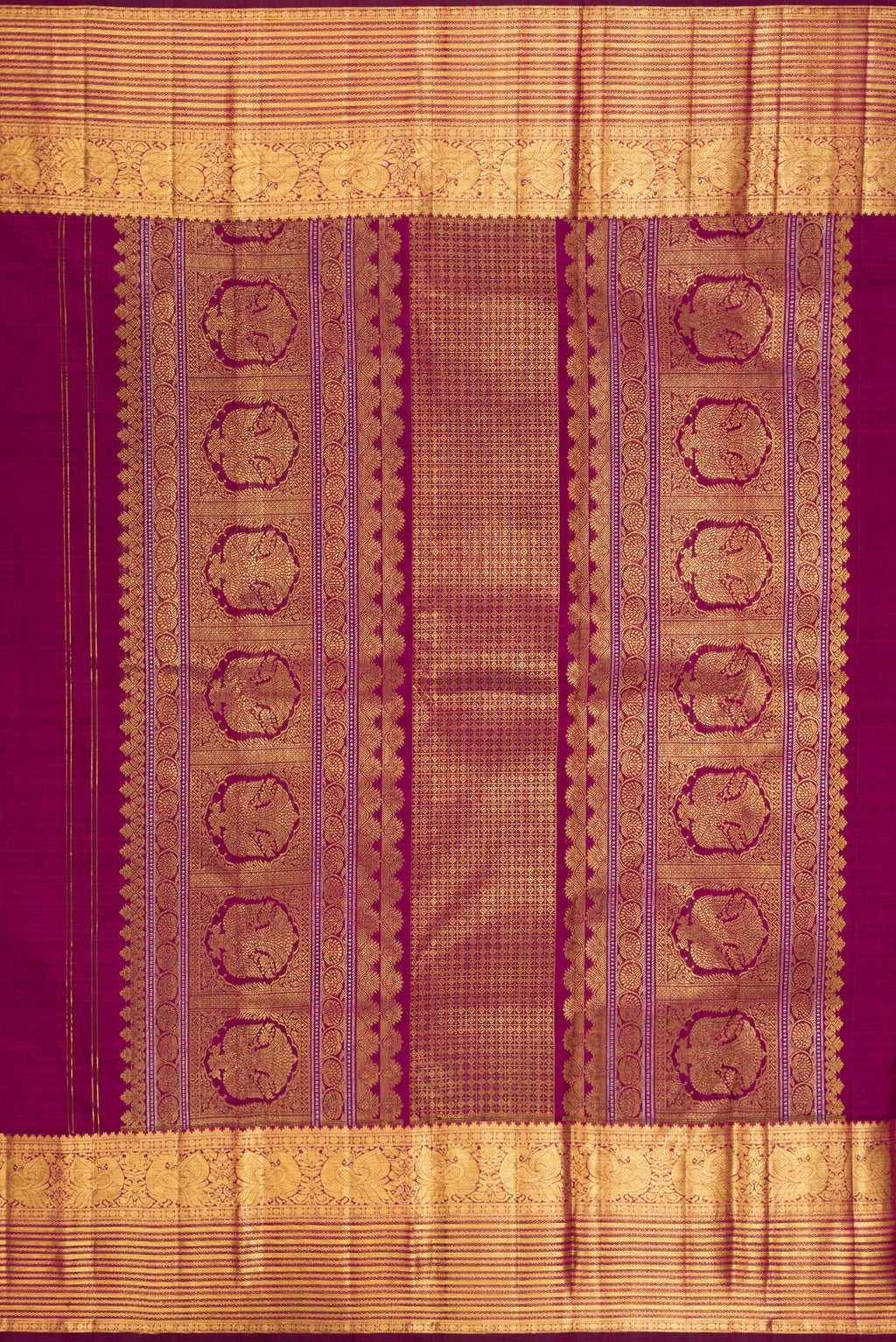 Close up image of the pallu of Pure Silk Magenta Kanjivaram Saree with Zari Butta on the body and Zari Border. 