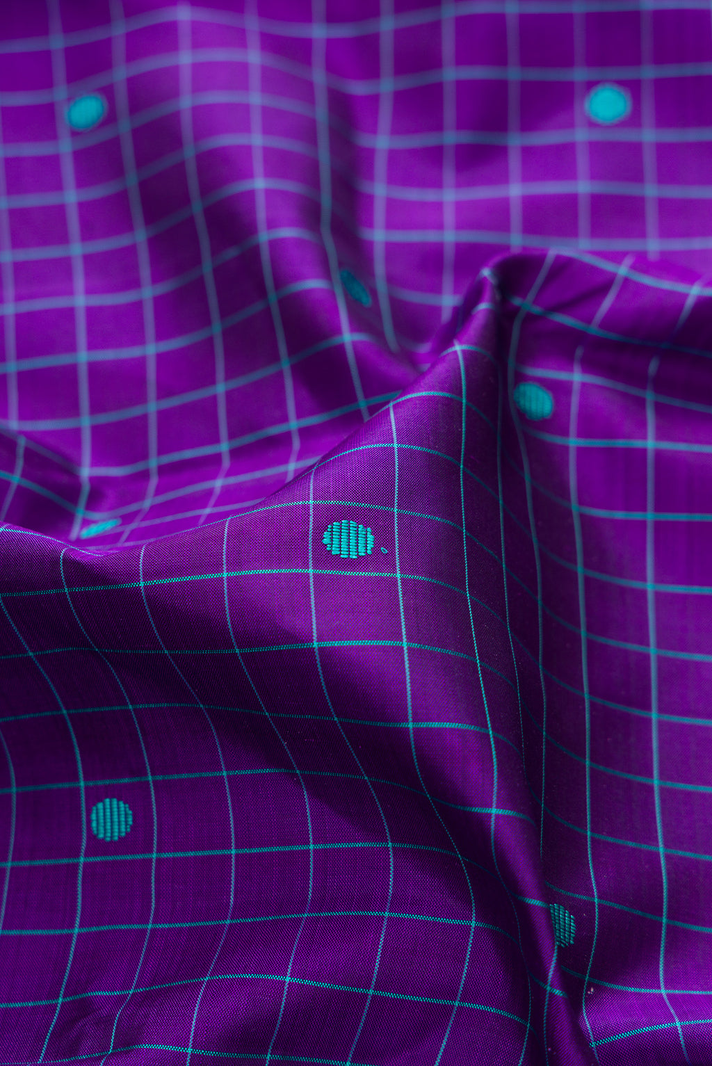 Close up of Pure Silk Violet Kanjivaram Saree with Checked design on the body and Plain Border.  displaying folds