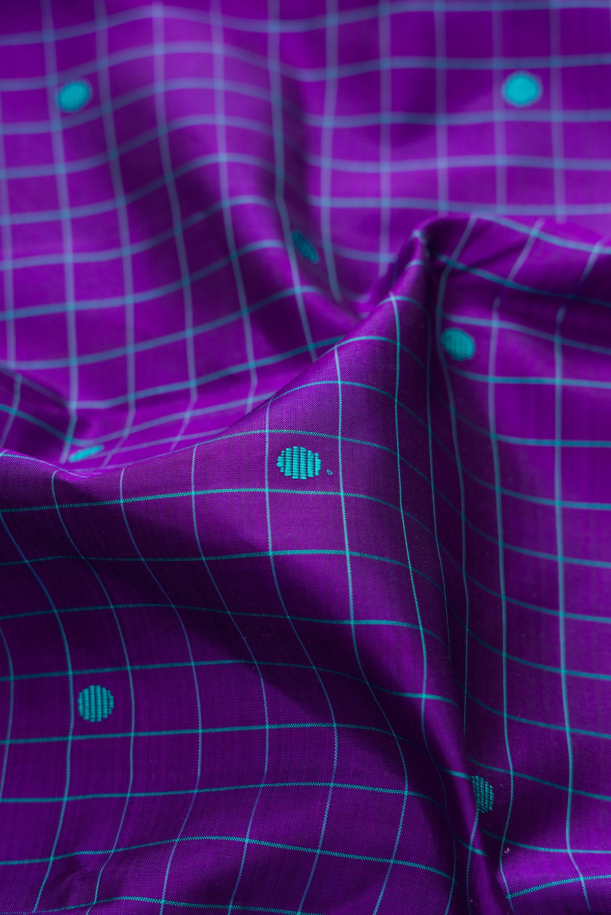 Close up of Pure Silk Violet Kanjivaram Saree with Checked design on the body and Plain Border.  displaying folds