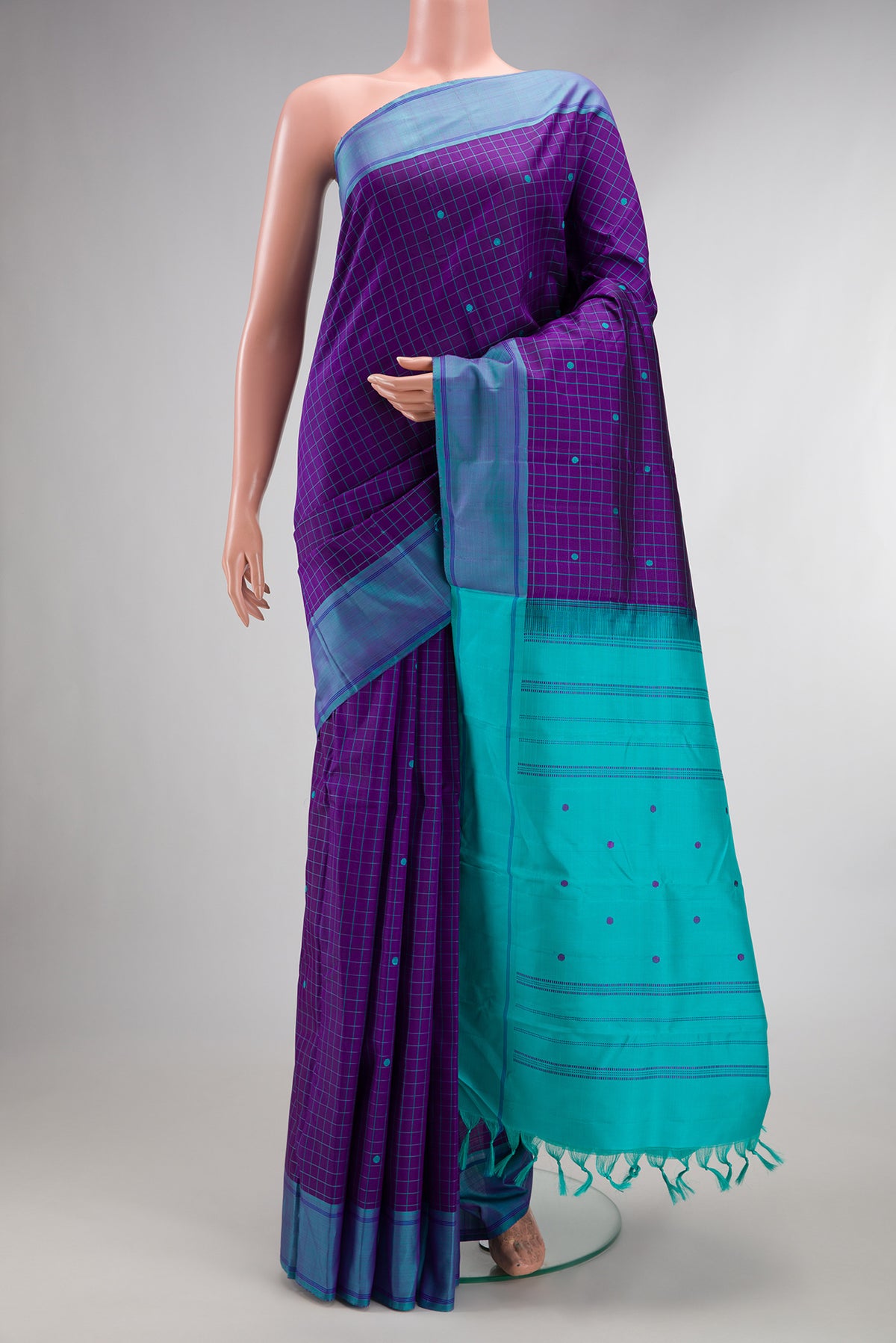 Pure Silk Violet Kanjivaram Saree with Checked design on the body and Plain Border.  displayed on a mannequin