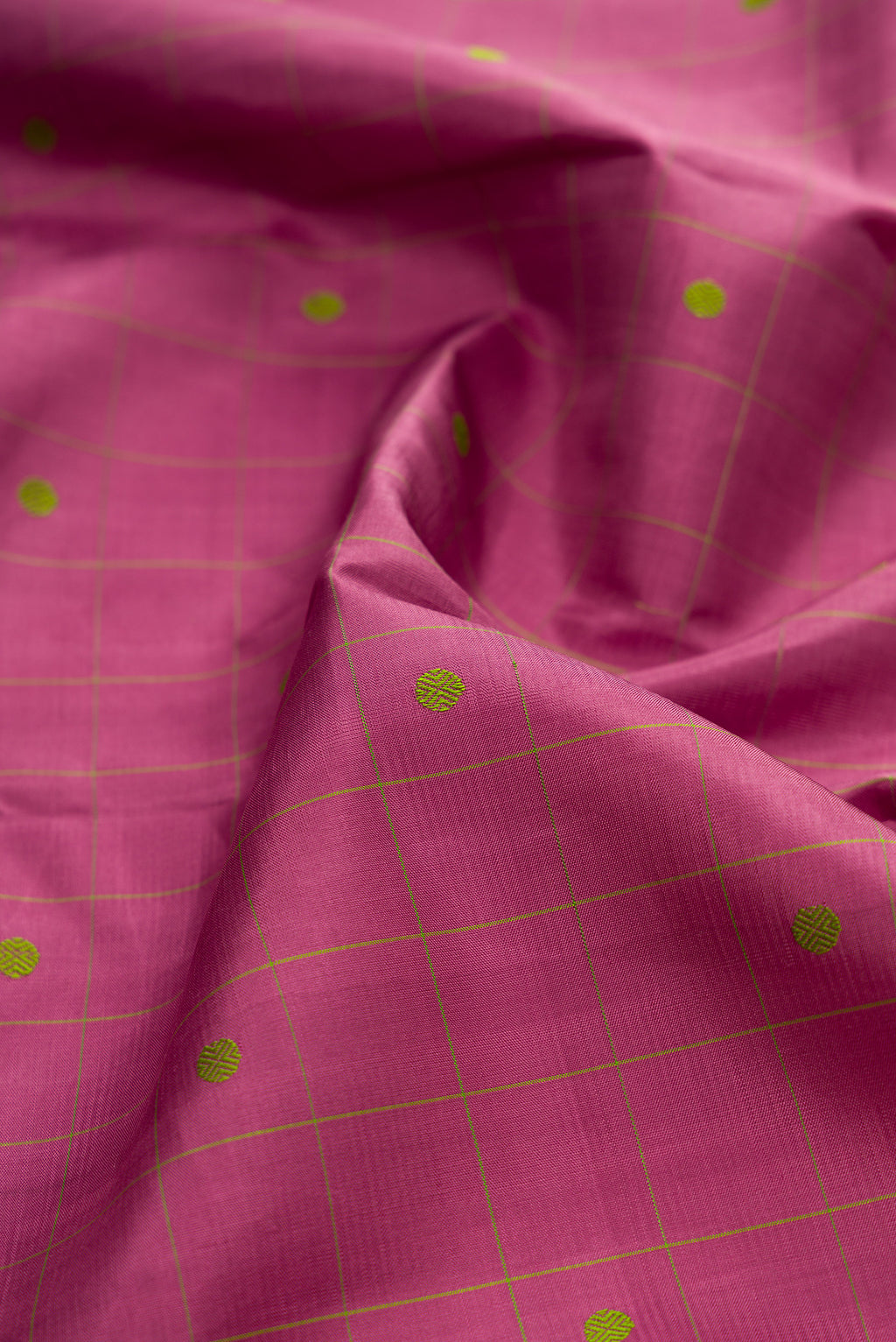 Close up of Pure Silk Pink Kanjivaram Saree with Checked design on the body and Plain Border.  displaying folds