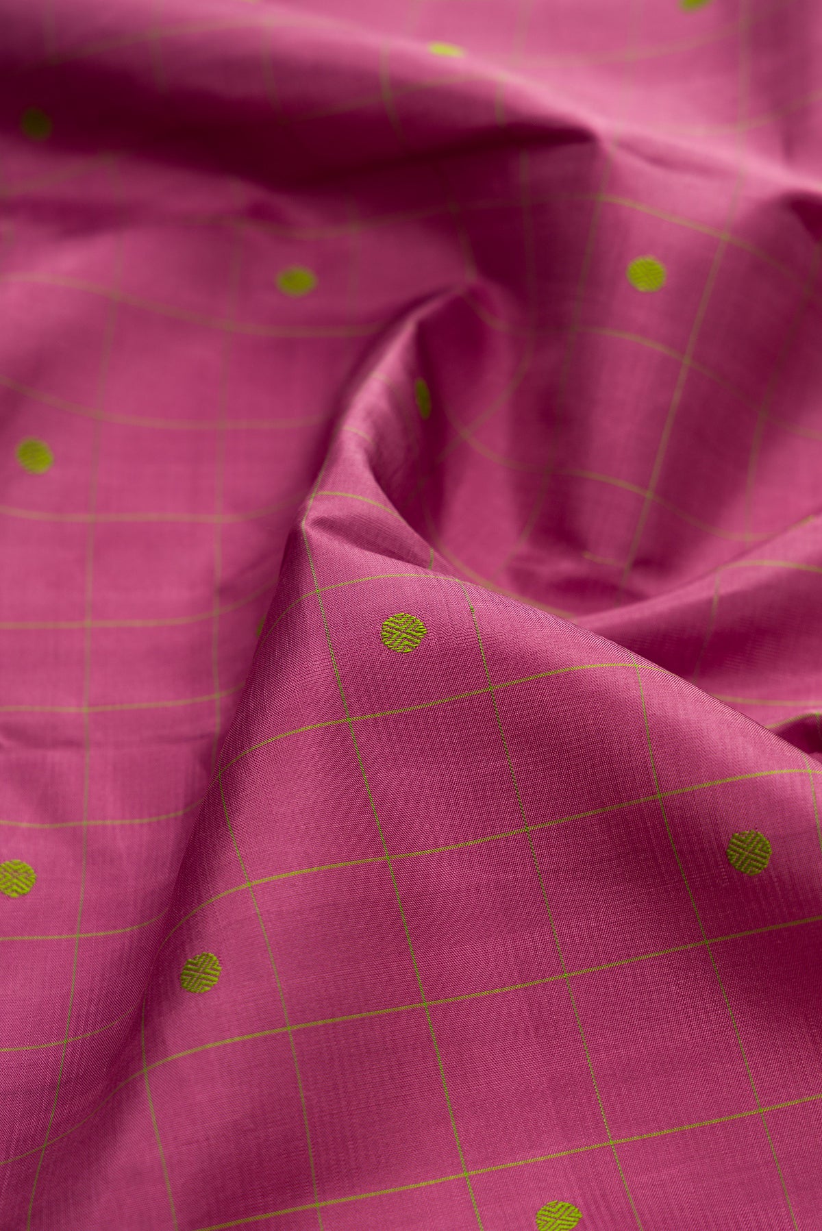 Close up of Pure Silk Pink Kanjivaram Saree with Checked design on the body and Plain Border.  displaying folds