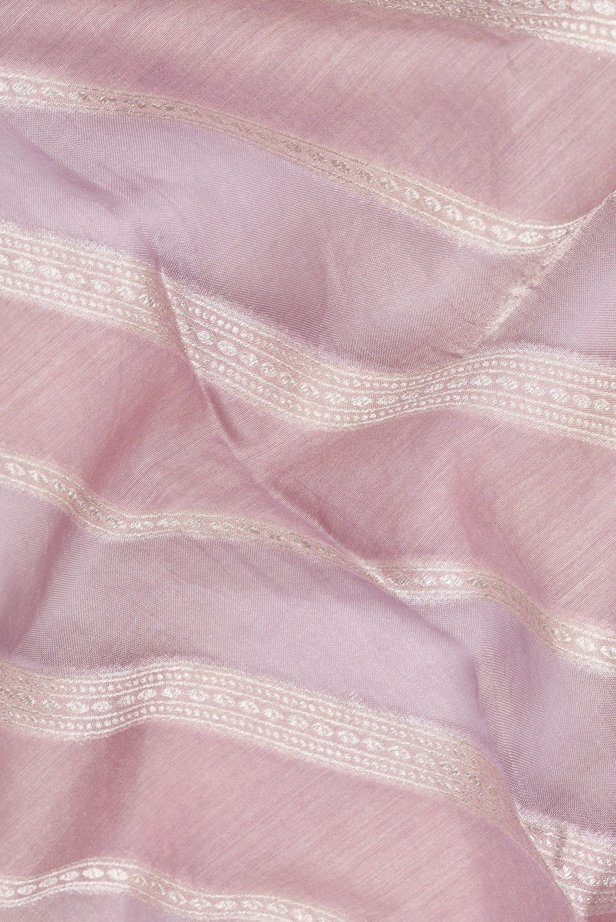 Close up of Lavender Dual Tone Tussar Saree with Zari Brocade on the body and Embroidered Border.  displaying folds
