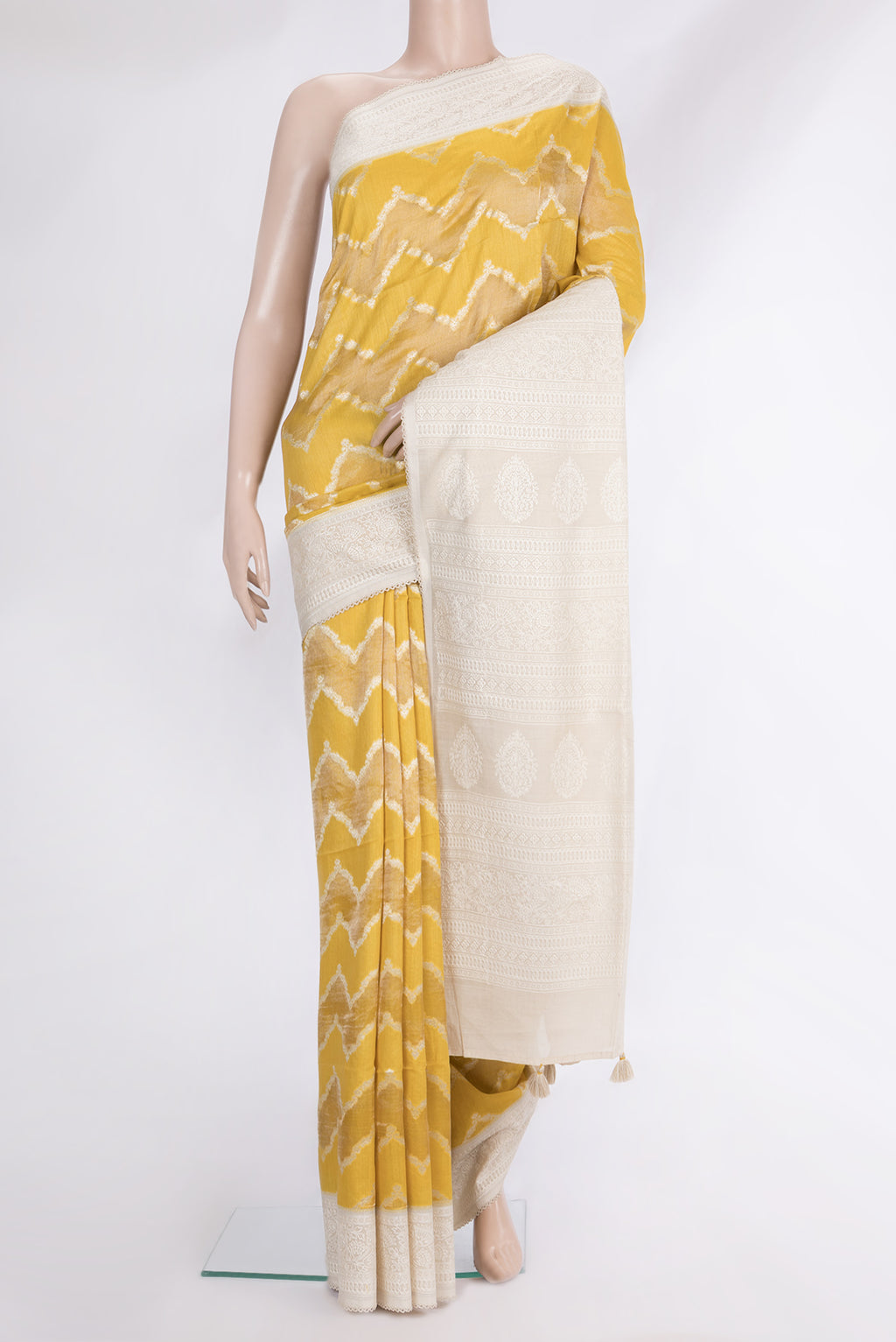 Yellow Tussar Saree with Zari Brocade on the body and Embroidered Border.  displayed on a mannequin